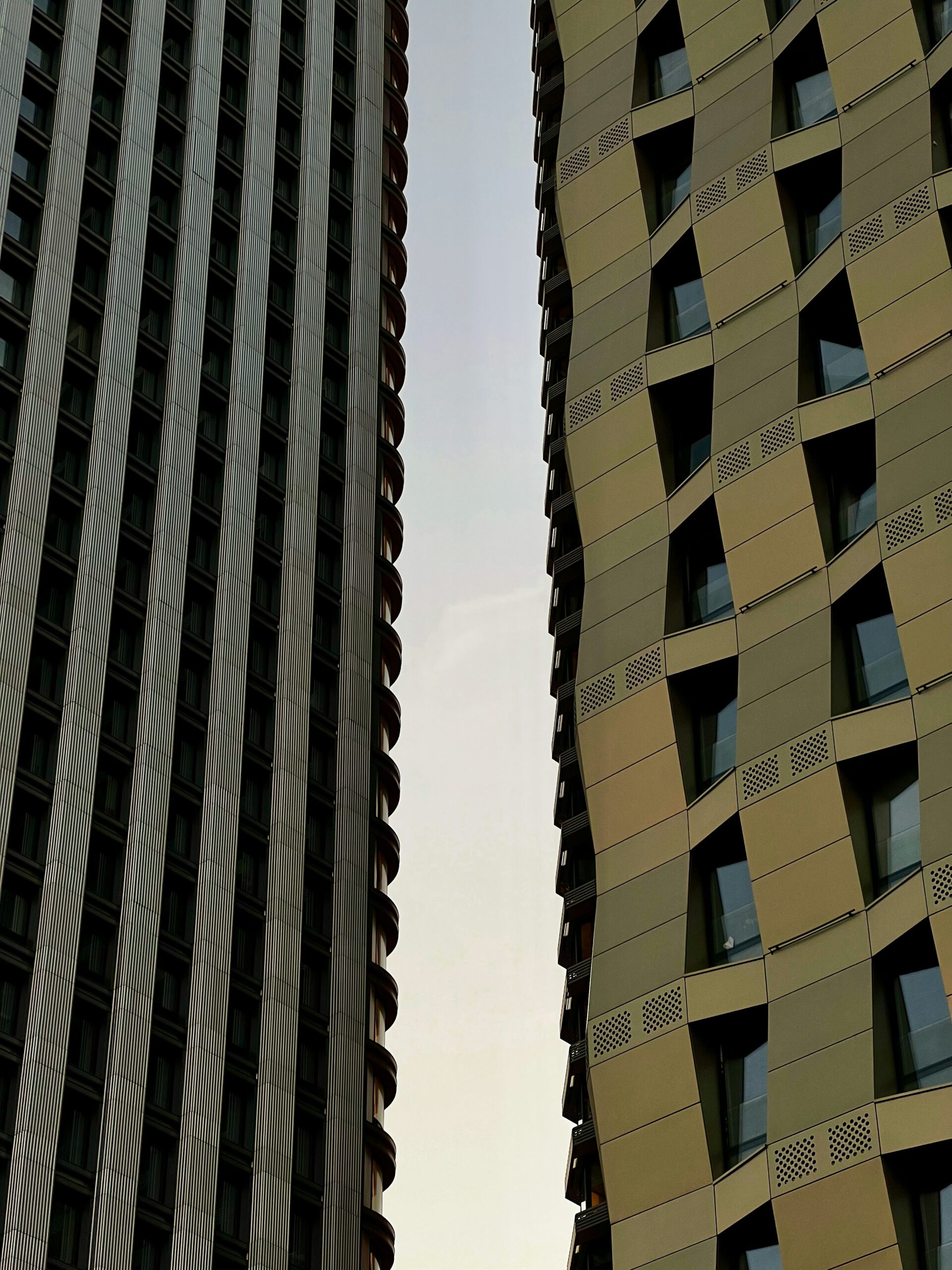 A couple of tall buildings next to each other